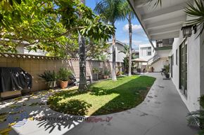 Long Beach apartment for rent - a courtyard with palm trees and a sidewalk
