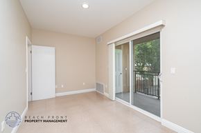 Harbor City apartment for rent - A spacious room with a sliding glass door leading to a balcony.