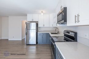 Long Beach apartment for rent - A kitchen with a stainless steel refrigerator, oven, and microwave.