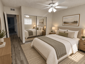 Downey apartment for rent - A bedroom with a large bed, a ceiling fan, and a painting on the wall.