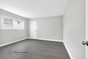 Inglewood apartment for rent - a bedroom with hardwood floors and grey walls