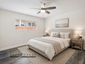 Whittier apartment for rent - A bedroom with a large bed, a ceiling fan, and a window with blinds.
