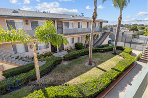 Gardena apartment for rent - an apartment building with a yard and palm trees