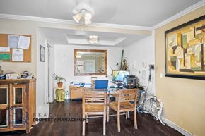 Wilmington apartment for rent - A room with a wooden table and chairs, a mirror, and a painting on the wall.