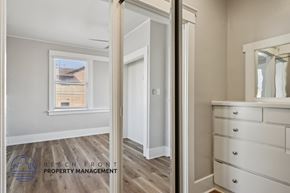 Long Beach apartment for rent - A white bedroom with a dresser and a mirror.