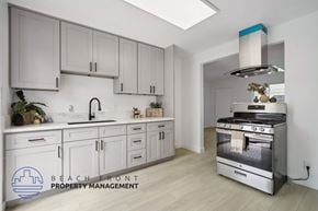 Buena Park apartment for rent - A modern kitchen with a stainless steel oven and white cabinets.