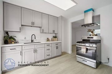 Buena Park apartment for rent - A modern kitchen with a stainless steel oven and white cabinets.