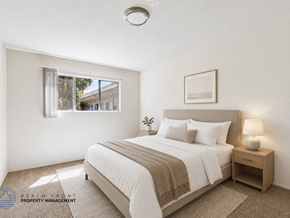 Inglewood apartment for rent - A well-lit bedroom with a large bed and a window.