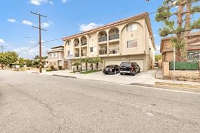 Hawthorne apartment for rent - A black car is parked in front of a building with a balcony.