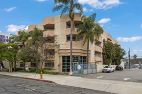 Long Beach apartment for rent - an apartment building with palm trees and a yellow fire hydrant