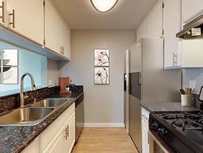 Lawndale apartment for rent - A kitchen with a stove top oven and a refrigerator.