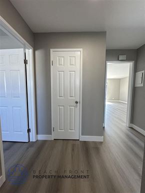 Redondo Beach apartment for rent - a bedroom with a white door and a hallway with wood floors
