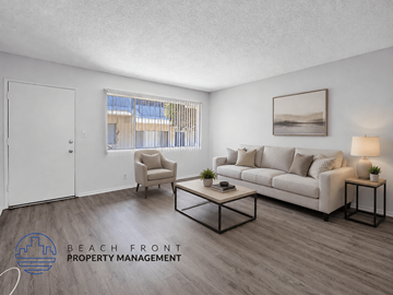 Inglewood apartment for rent - A living room with a white sofa, a chair, a coffee table, and a painting on the wall.