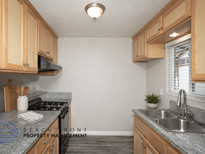 Norwalk apartment for rent - A kitchen with granite countertops and wooden cabinets.
