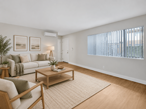 Downey apartment for rent - A living room with a couch, coffee table, and a plant.