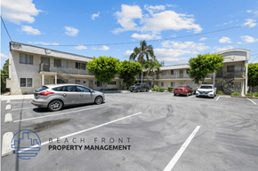Long Beach apartment for rent - a parking lot in front of an apartment building with cars parked in front