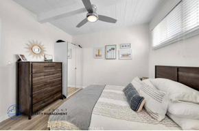 Hermosa Beach apartment for rent - a bedroom with a bed and a ceiling fan