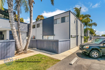 Costa Mesa apartment for rent - A modern house with a green lawn and a tree in front of it.