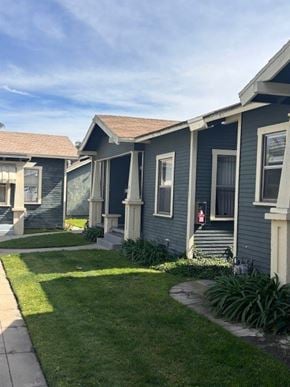 Anaheim apartment for rent - A row of houses with green lawns in front.
