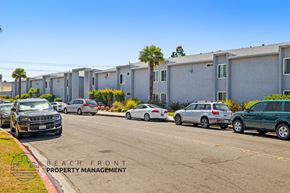 Anaheim apartment for rent - a city street with cars parked in front of a building