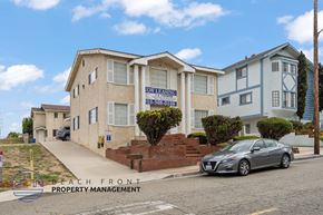 Redondo Beach apartment for rent - A car is parked in front of a house with a sign that says "Owning" on it.