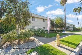 Torrance apartment for rent - A building with a sign that says Beach Front Property Management.