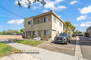Inglewood apartment for rent - A two-story building with a sign that says "BEACH FRONT PROPERTY MANAGEMENT" in front of it.