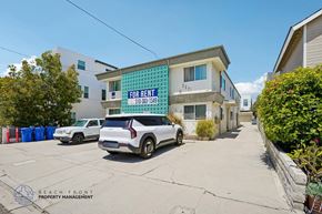 Redondo Beach apartment for rent - A white car is parked in front of a building with a for rent sign.