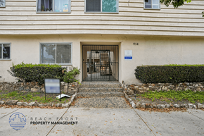 San Pedro apartment for rent - A building with a gate and a sign that says Beach Front Property Management.