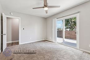 Torrance townhouse for rent - A spacious room with a ceiling fan and sliding glass doors leading to a backyard.