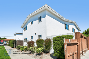 Long Beach apartment for rent - A white house with a brown fence in front of it.