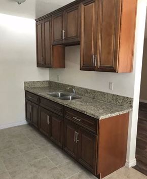 Inglewood apartment for rent - a kitchen with wooden cabinets and granite counter top and a sink
