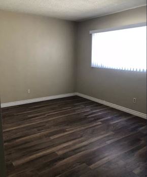 Inglewood apartment for rent - an empty room with wooden floors and a window
