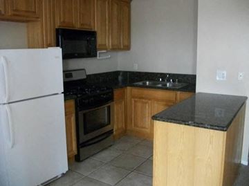 Long Beach apartment for rent - a kitchen with a stove refrigerator and a sink