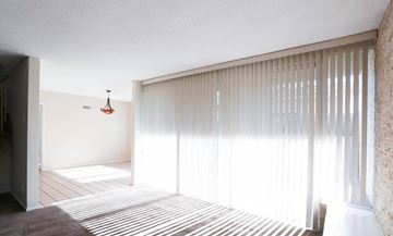 Inglewood apartment for rent - a living room with white blinds and a striped rug
