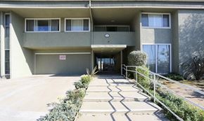 Inglewood apartment for rent - the front of an apartment building with stairs and a driveway
