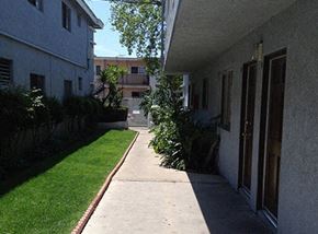 Wilmington apartment for rent - A long concrete walkway leads between two buildings.