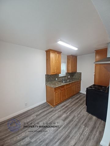 Long Beach apartment for rent - a kitchen with wooden cabinets and granite counter tops