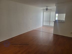Harbor City apartment for rent - the interior of a living room with wood floors and a ceiling fan