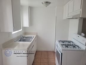 Harbor City apartment for rent - a small kitchen with a sink and a stove and a refrigerator