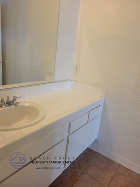 Harbor City apartment for rent - a white bathroom with a sink and a mirror