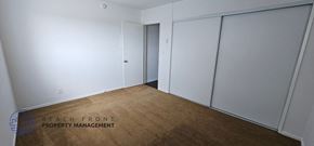 Inglewood apartment for rent - a bedroom with white walls and a carpet and two closets