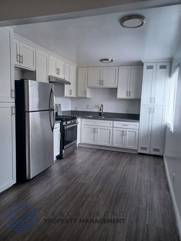 Los Angeles apartment for rent - a kitchen with white cabinets and a stainless steel refrigerator