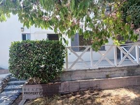 Redondo Beach triplex for rent - A white fence with a sign that says "Beach Property" in front of a building.
