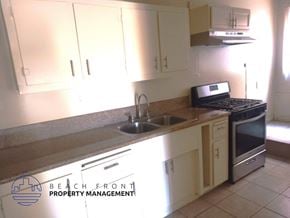 Redondo Beach triplex for rent - A kitchen with a sink, stove, and cabinets.