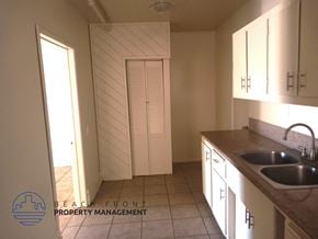 Redondo Beach triplex for rent - A kitchen with a sink and cabinets.