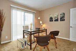 Torrance apartment for rent - a desk and chairs in a living room with a large window
