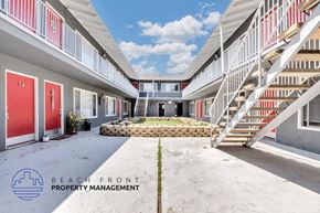 Long Beach apartment for rent - a courtyard between two apartment buildings with stairs and a flower bed