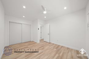 Torrance apartment for rent - a bedroom with white walls and wood flooring and white closet doors