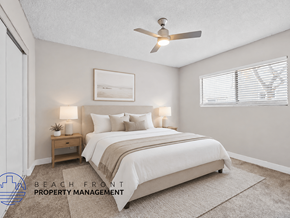 Anaheim apartment for rent - A bedroom with a bed, nightstand, and a ceiling fan.
